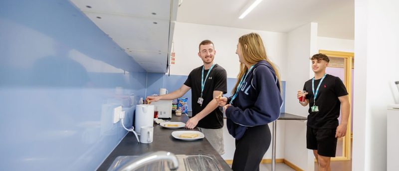 Students making toast in HE accommodation kitchen