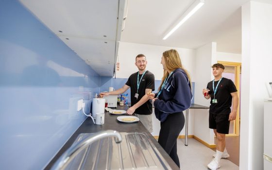 Students making toast in HE accommodation kitchen