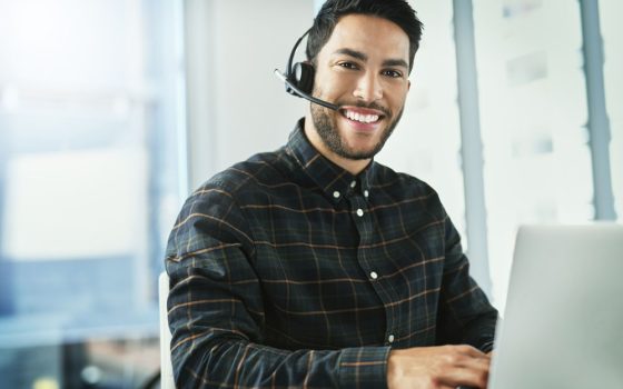 Man at PC with ear piece