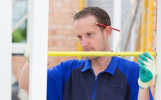 Man measuring window