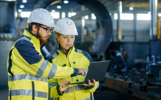 Builders looking at laptop