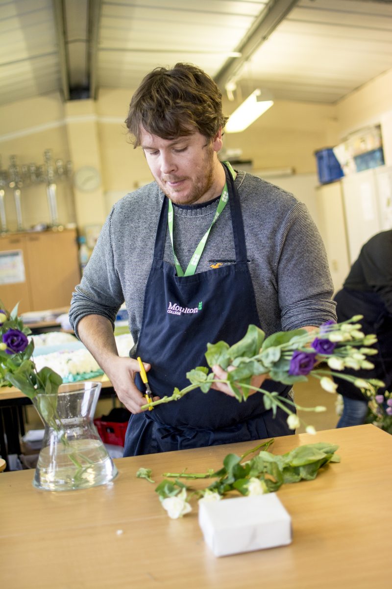 Student arranging flowers