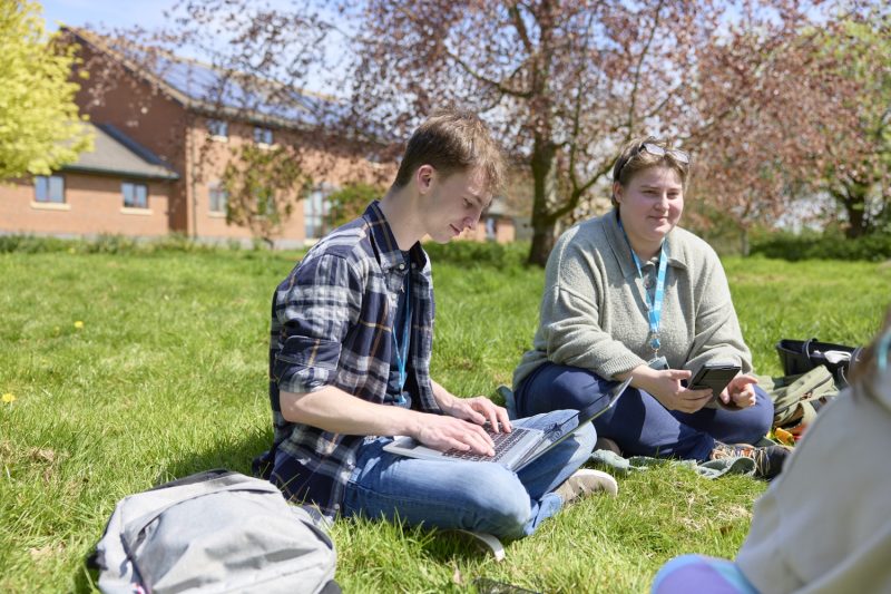 Students studying outside with laptop