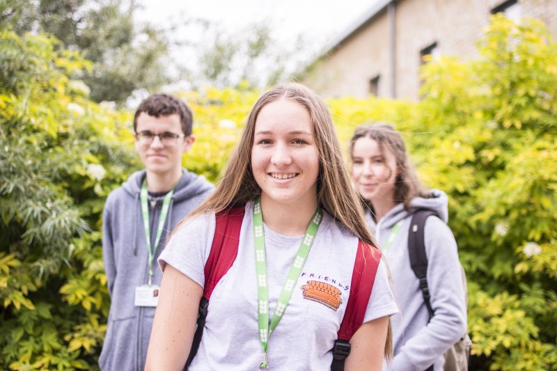 Students on campus looking at camera