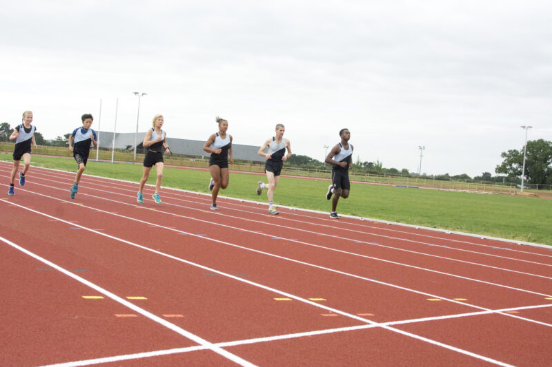 Athletic academy team training on the track.