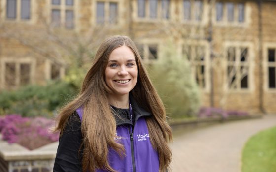 Careers Advisor smiling wearing a purple moulton vest