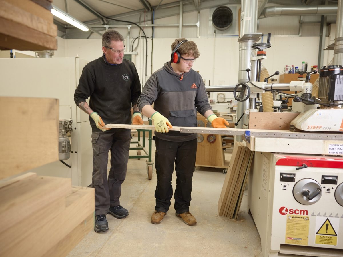 Furniture Studies student with NBJ team using machinery in the workshop.