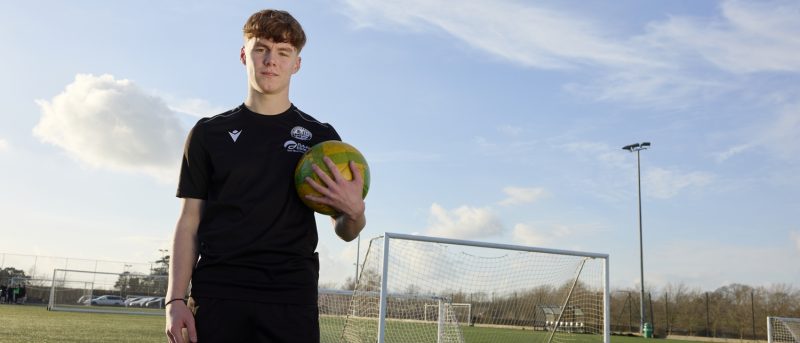 Football Academy Student, holding ball in front of goal