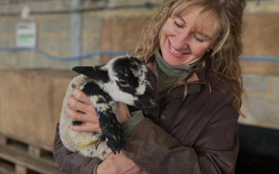 Attendee holding black and white lamb