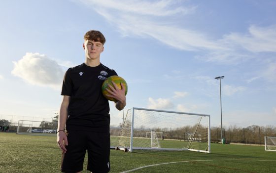 Football Academy Student, holding ball in front of goal